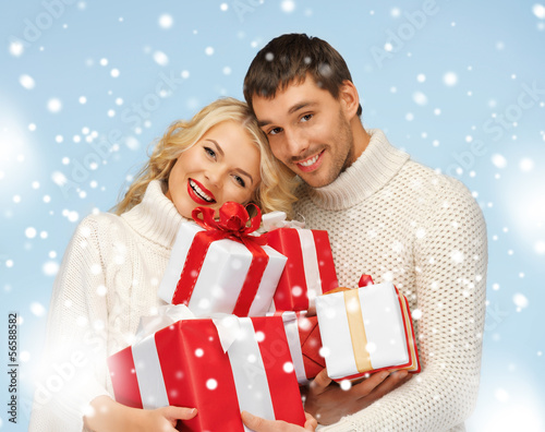 Photo: happy man and woman with many gift boxes happy man and woman with many gift boxes
