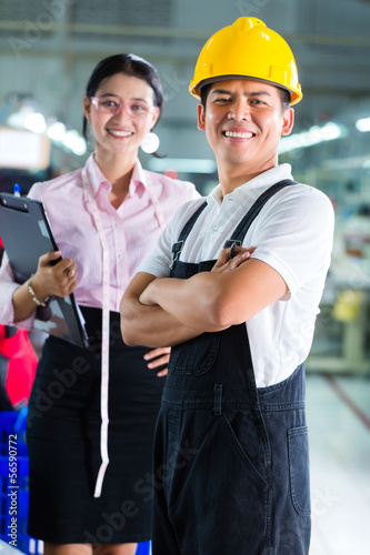 Photo: Production manager and designer in Asian factory Production manager and designer in Asian factory