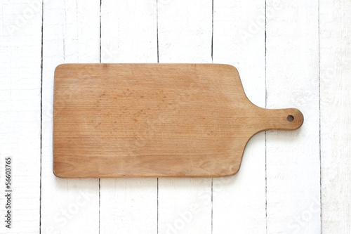 Photo: Empty cutting board on white planks food background concept Empty cutting board on white planks food background concept