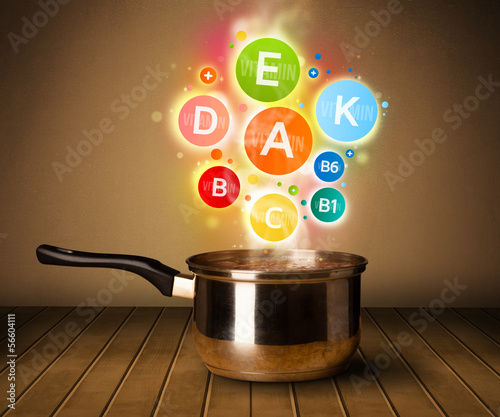 Photo: Colorful vitamins coming out from cooking pot Colorful vitamins coming out from cooking pot