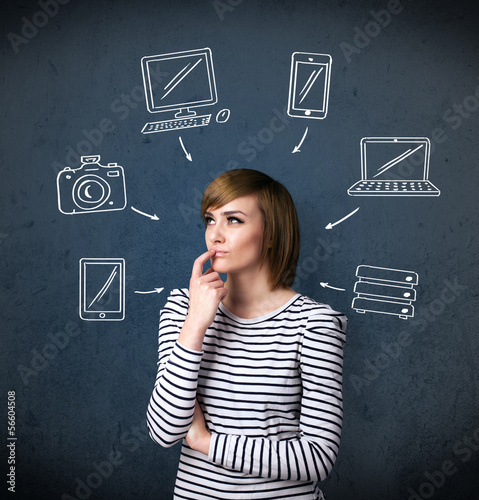 Photo: Young woman thinking with drawn gadgets around her head Young woman thinking with drawn gadgets around her head