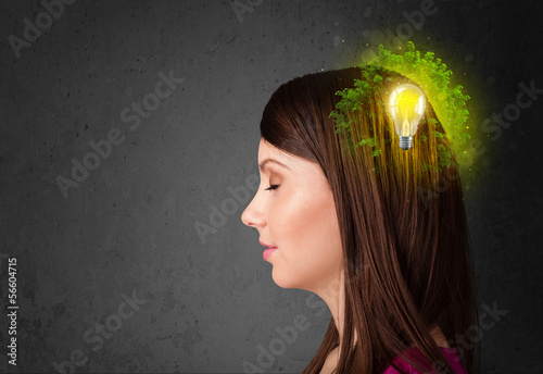 Photo: Young mind thinking of green eco energy with lightbulb Young mind thinking of green eco energy with lightbulb