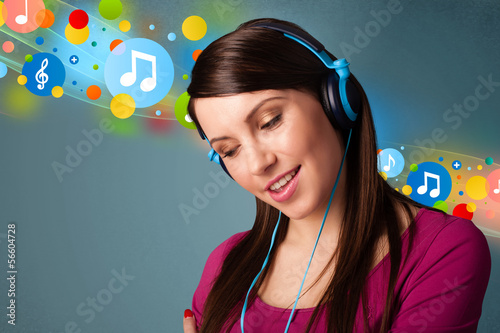 Photo: Young woman listening to music with headphones Young woman listening to music with headphones