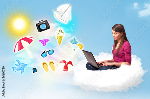 Photo: Young businessman sitting in cloud with laptop Young businessman sitting in cloud with laptop