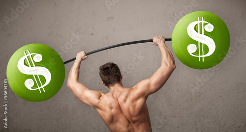 Photo: muscular man lifting green dollar sign weights muscular man lifting green dollar sign weights