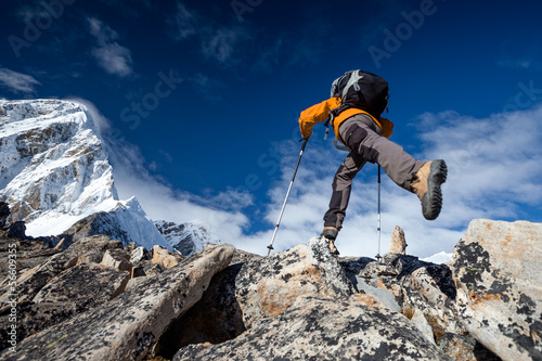 Photo: Hiker jumps on the rock near Everest in Nepal Hiker jumps on the rock near Everest in Nepal