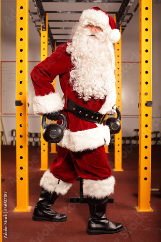 Photo: Santa Claus training before Christmas in gym - kettlebells Santa Claus training before Christmas in gym - kettlebells