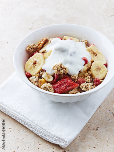 Photo: Granola with dried fruits and yogurt in a bowl Granola with dried fruits and yogurt in a bowl