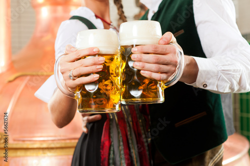 Photo: Man and woman with beer glass in brewery Man and woman with beer glass in brewery
