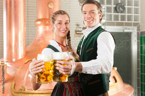 Photo: Man and woman with beer glass in brewery Man and woman with beer glass in brewery