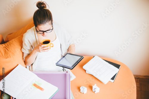 Photo: Young woman studying and drinking coffee Young woman studying and drinking coffee