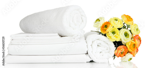 Photo: Stack of clean bedding sheets and towels isolated on white Stack of clean bedding sheets and towels isolated on white
