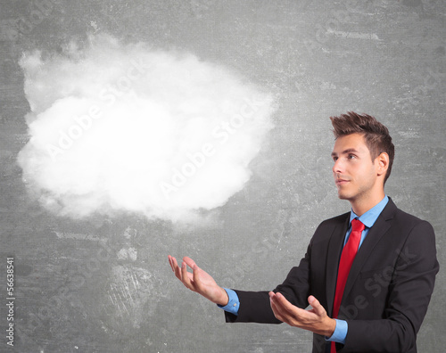 Photo: business man holding a cloud on his hands business man holding a cloud on his hands