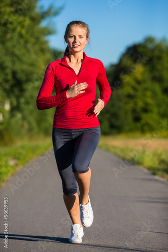 Photo: Urban leisure - woman running outdoor Urban leisure - woman running outdoor