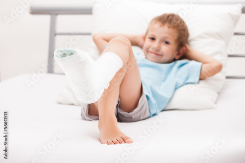 Photo: Little child boy with plaster bandage on leg heel fracture or br Little child boy with plaster bandage on leg heel fracture or br