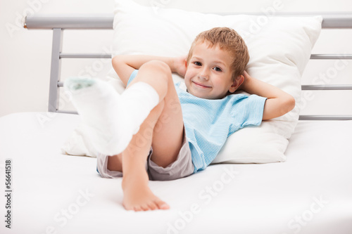 Photo: Little child boy with plaster bandage on leg heel fracture or br Little child boy with plaster bandage on leg heel fracture or br