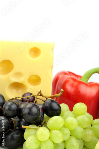 Photo: Cheese, red pepper and grapes on white background. Cheese, red pepper and grapes on white background.
