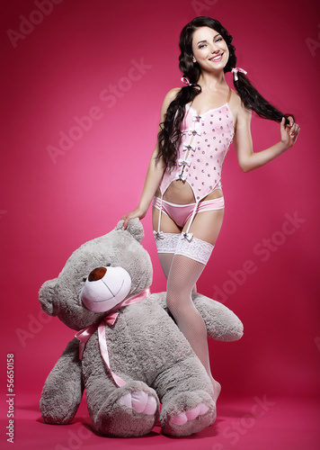 Photo: Birthday. Playful Enticing Woman holding her Gift - Teddy Bear Birthday. Playful Enticing Woman holding her Gift - Teddy Bear