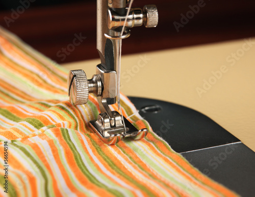 Photo: Sewing machine working part with striped cloth Sewing machine working part with striped cloth
