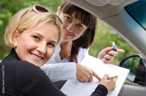 Photo: Proud successful woman purchasing a car Proud successful woman purchasing a car