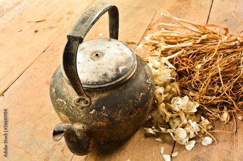 Photo: Old kettle on old wooden table Old kettle on old wooden table