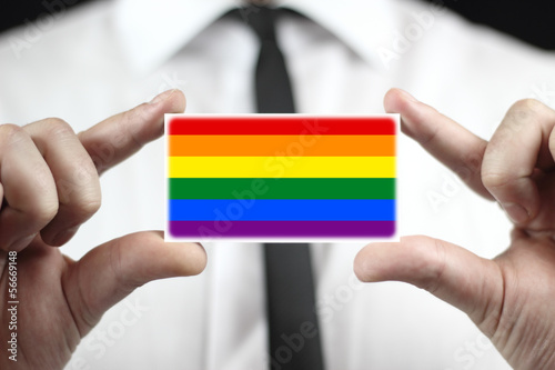 Photo: Businessman holding a business card with a Rainbow Flag Businessman holding a business card with a Rainbow Flag