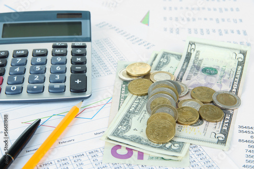 Photo: Office supplies with money and documents close up Office supplies with money and documents close up