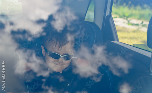 Photo: Boy in car with glasses Boy in car with glasses