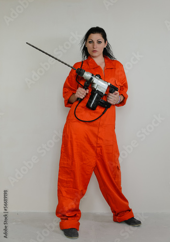 Photo: Woman with a masonry drill Woman with a masonry drill