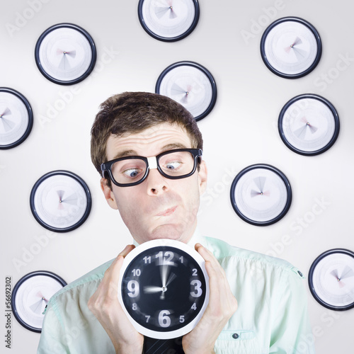 Photo: Time concept of a businessman holding quick clock Time concept of a businessman holding quick clock