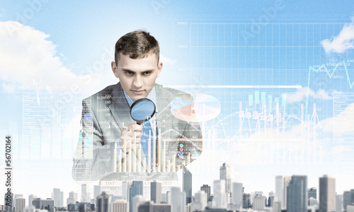 Photo: Man looking in magnifier Man looking in magnifier