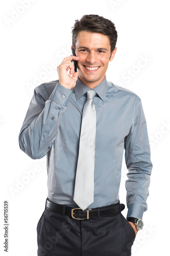 Photo: Smiling Businessman Talking On Cell Phone Smiling Businessman Talking On Cell Phone