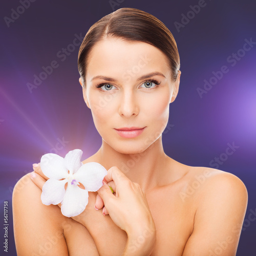 Photo: relaxed woman with orhid flower relaxed woman with orhid flower