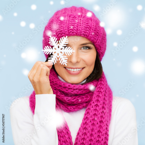Photo: woman in hat and muffler with big snowflake woman in hat and muffler with big snowflake