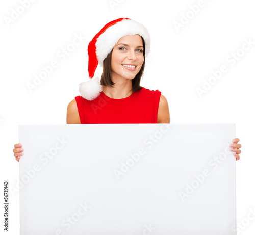 Photo: woman in santa helper hat with blank white board woman in santa helper hat with blank white board