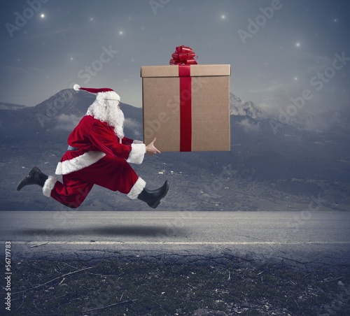 Photo: Running Santa Claus with big gift Running Santa Claus with big gift