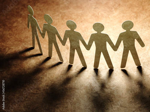 Photo: Group of paper people holding hands. Group of paper people holding hands.