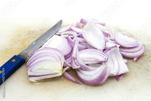 Photo: Sliced Red Onion with Knife and Chopping Block. Sliced Red Onion with Knife and Chopping Block.