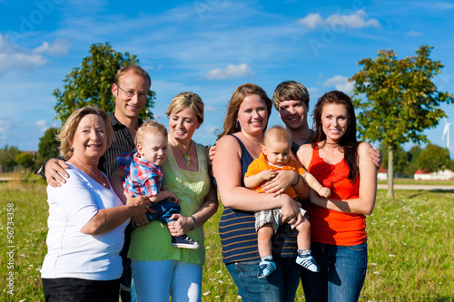 Photo: Family and multi-generation - fun on meadow in summer Family and multi-generation - fun on meadow in summer