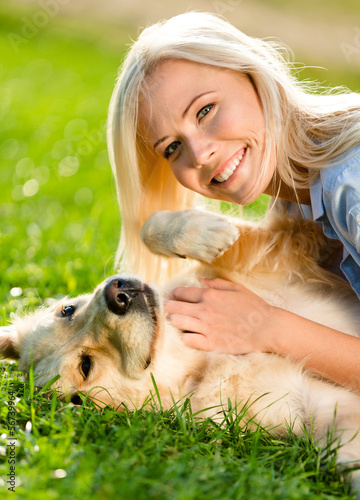 Photo: Close up of girl who strokes golden retriever Close up of girl who strokes golden retriever