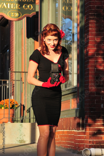 Photo: lady using vintage camera lady using vintage camera