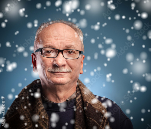Photo: winter concept - elderly man looks skeptically winter concept - elderly man looks skeptically