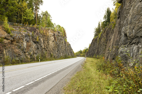Photo: Highway among granite rocks in early autumn. Highway among granite rocks in early autumn.