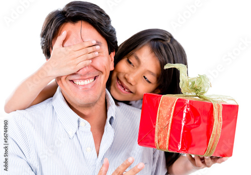Photo: Girl giving father a present Girl giving father a present
