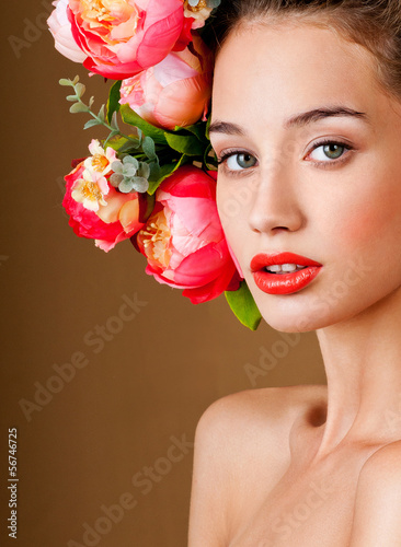 Photo: fashion model with hairstyle and flowers in her hair. fashion model with hairstyle and flowers in her hair.