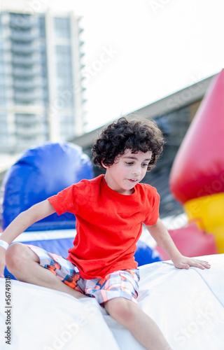 Photo: Child Playing in an Inflatable Playground Child Playing in an Inflatable Playground