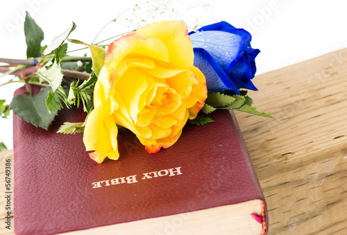 Photo: Flowers and Bible over a Cross Flowers and Bible over a Cross