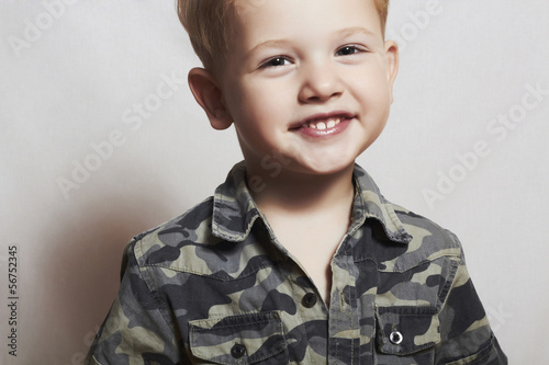 Photo: smiling child. funny little boy. 4 eyers old. military shirt smiling child. funny little boy. 4 eyers old. military shirt