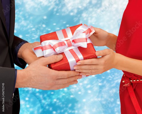 Photo: man and woman hands with gift box man and woman hands with gift box