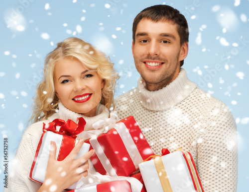 Photo: happy man and woman with many gift boxes happy man and woman with many gift boxes